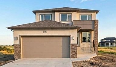 beige exterior 2 story double attached garage